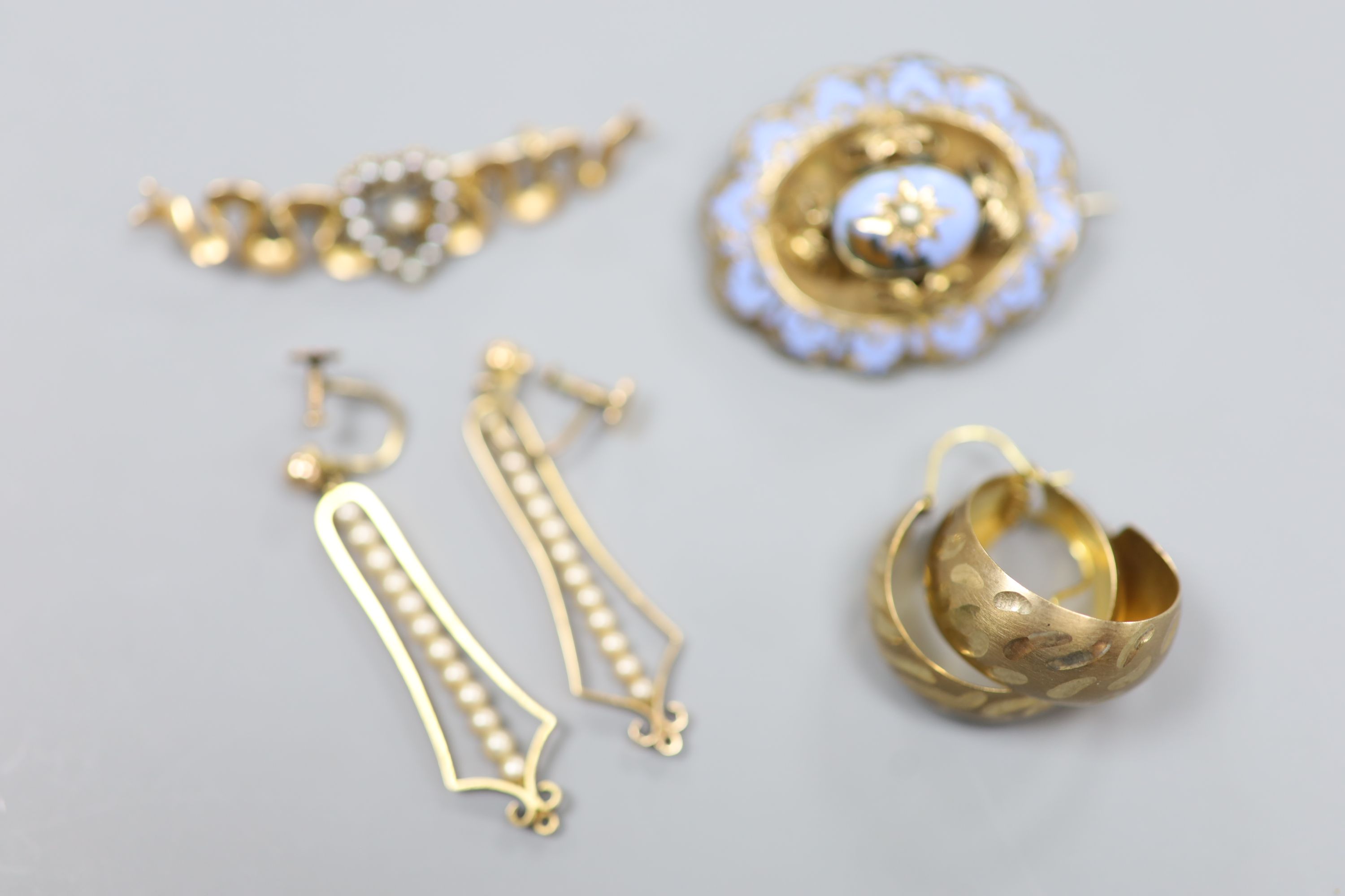 An Edwardian 15ct and seed pearl set bar brooch, 47mm, gross 4 grams, two pairs of 9ct earrings, gross 5,2 grams and a Victorian yellow metal and enamel (a.f.) mourning brooch.